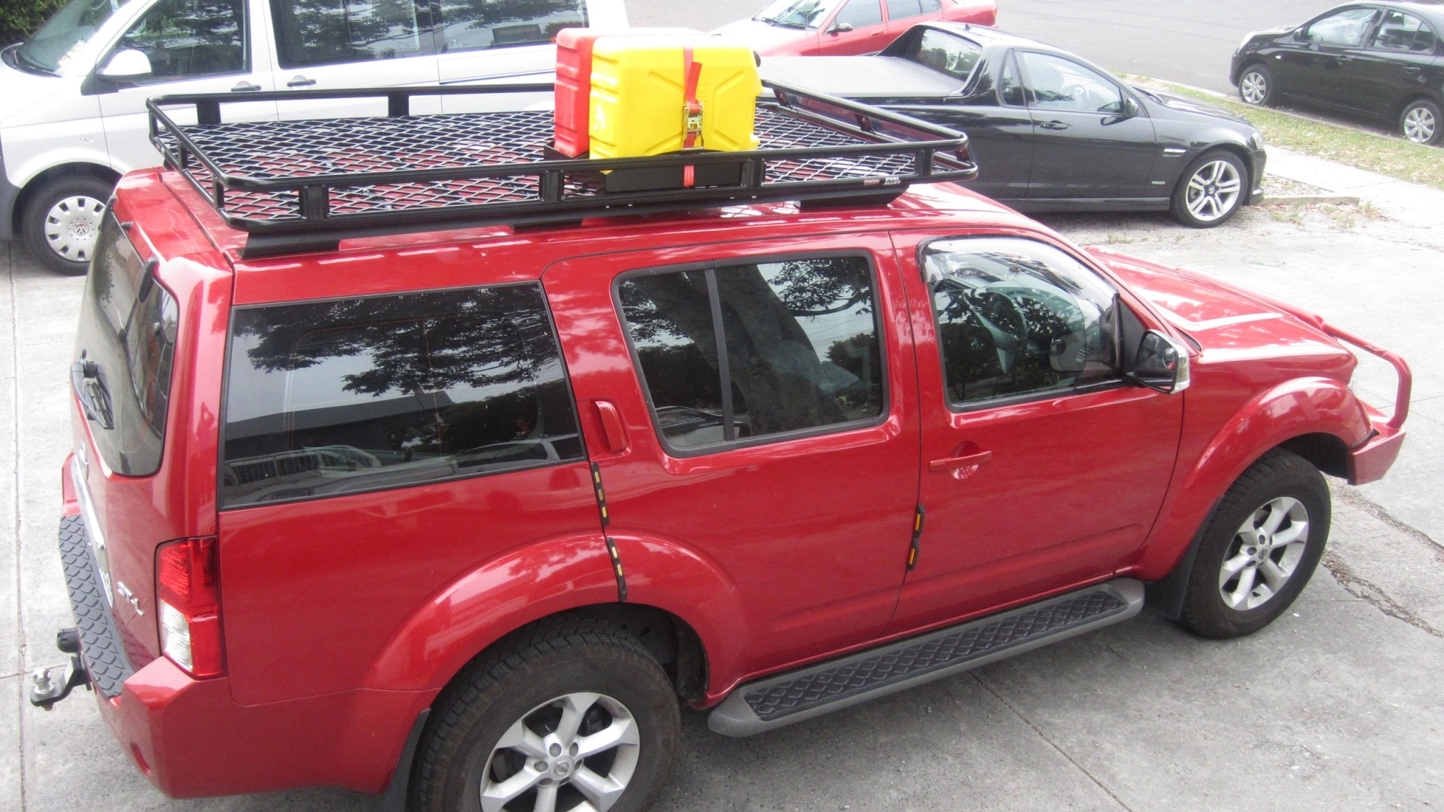 Nissan Pathfinder with Oval Alloy basket style roof rack with a mesh floor and 2 jerry can holders fitted